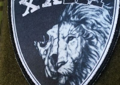 XXIII prinditud embleem takjaalusega